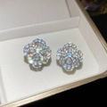 Close-up of sparkling flower-shaped stud earrings with brilliant zircons in a jewelry box - No.64 Four-Petal Flower Full Pave Style / Silver