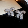 Close-up of sparkling vintage bow-knot rhinestone stud earrings with bright facets - Silver Pleated Design Pave Zirconia Bowknot Stud (15# Silver Earring Post - Silver) / Silver