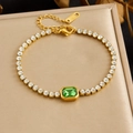 Macro detail of a gold-plated stainless steel bracelet with green and clear zircon stones - Rectangular Main Stone (B2109) / Green