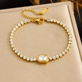 Elegant detail of a gold-plated stainless steel bracelet featuring square cubic zirconia stones - Rectangular Main Stone (B2112) / White