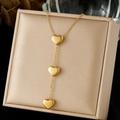 Elegant gold double-layer stainless steel necklace featuring three polished heart pendants - Triple Heart Long Pendant Style (N4145)