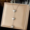 Silver triple heart charm long necklace in stainless steel on golden jewelry box - Triple Heart Long Pendant Style (N4146)