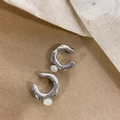 Detail view of silver textured ear cuff with small white pearl on kraft paper - Ear Cuffs / Silver