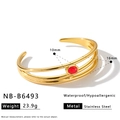 Dettaglio di un bracciale rigido a tre strati in acciaio dorato con pietra rossa - Bracciale Cavo a Tre Strati con Pietra Rossa (NB-B6493) / Oro 18K