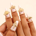 Detailed macro view of gold ocean-themed nail rings with sparkling zircons on nails - Ocean Style Set (96) / Five-Piece Set / Gold