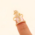 Detailed macro view of a gold-plated seahorse nail ring set with clear cubic zirconia stones. - Seahorse Style (5305) / KC Gold