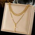Three-layer gold-plated stainless steel necklace with cross pendant on beige display - Triple Layer Cross Style (N4147)