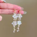 Close-up of elegant white acrylic flower drop earrings with shimmering crystal details - Sweet Exquisite Petal Style (24#)