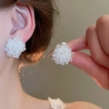 Detailed close-up showing elegant white acrylic cluster flower stud earrings worn on ear - Style 46 / White