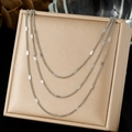 Minimalist silver triple-layer necklace with flat polished sequins on a jewelry box - Triple Layer Sequin Style (N4150)