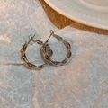 Detailed view of minimalist silver twisted hoop earrings with elegant metallic texture - Silver Twist Earrings with Silver Needles