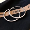 Close-up of silver minimalist large hoop earrings on a textured black background - Large / Silver Earring Post Style / Silver