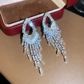 Detailed macro view of luxury zircon tassel earrings with a brilliant starburst effect - No. 52 Silver Earring Post Style / Gold-White