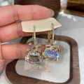 Detailed close-up of elegant brown zircon flower earrings with iridescent crystals - Gold Flower / White