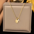 Baroque style gold necklace with an oval metal pendant and a small white pearl accent - H1069 Pearl Oval Necklace Gold