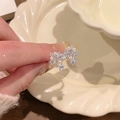 Detail view of a silver double butterfly ring with dainty pearls and sparkling crystals. - Adjustable / Silver