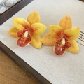 Detailed close-up of yellow resin orchid flower earrings with silver needles for women - Style 40 (Silver Pin)