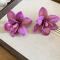 Detailed macro view of vibrant purple orchid-shaped resin flower stud earrings on tray - Style 39 (Silver Pin)