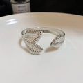 Detailed close-up of a silver leaf-shaped open cuff bracelet on white surface - Double Leaf Design Style (55#) / Silver