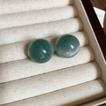 Detailed close-up of translucent teal round stud earrings resting in a beige jewelry box - Cyan Cat's Eye Texture Stud Earrings (48#) / Large / Blue