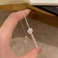 Elegant silver bracelet with a sparkling zircon camellia flower and row of pearls. - Silver/White
