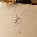 Detailed shot of minimalist silver stainless steel necklace with teardrop pendant and tassel. - Silver Long Stainless Steel Tassel Waterdrop Pendant (N4200)