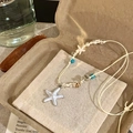 Detail of a handmade starfish and shell beaded woven necklace for beach vacation. - Necklace (HN11559) / White