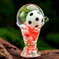 Detailed close-up of acrylic trophy keychain with floating beads and miniature soccer ball - Red