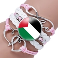 Close-up of multilayered braided bracelet with Palestine flag glass dome and Love charm - Pink White