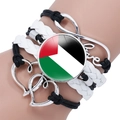 Detail of multi-layer Palestine flag bracelet with infinity and love charms on wrist - Black & White