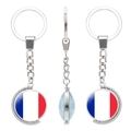 Rotating keychain showing French flag and world map detail on polished silver metal - France Style