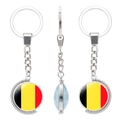 Rotating metal keychain with Belgium flag design shown from three different perspectives - Belgium Style