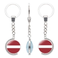 Rotating keychain featuring Latvia flag glass cabochon and silver metal globe charm - Latvia