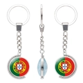Rotating metal keychain featuring Portugal flag glass dome charm with silver ring - Portugal Style