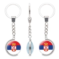 Rotating keychain with Serbia flag emblem on silver polished metal round pendant - Serbia