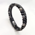 Macro detail of men's leather braided bracelet with tiger eye beads and magnetic clasp - Flash Stone + Black Glossy Beads