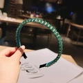 Detailed shot of emerald green crystal beads hand-woven with gold wire on a headband - Green Crystal