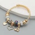 Gold stainless steel cable bracelet with beads, heart and swan charms, stylish design - Black