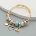 Verstelbare gouden roestvrijstalen armband met zwaan, hartbedeltjes en kristallen kralen - Blauw