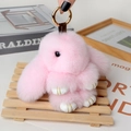 Detailed shot of pink faux fur rabbit pendant with golden clasp and leather paws - Large / Light Pink