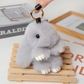 Detailed close-up of a fluffy grey plush rabbit keychain with premium gold hardware and texture - Large / Light Gray