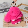 Detail of rose pink plush bunny pendant with gold clasp and monogram leather strap - Large / Rose Red