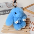 Close-up of a sky blue plush rabbit keychain with fluffy fur and gold hardware - Large / Sky Blue