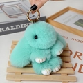 Close-up of mint green plush bunny keychain with gold hardware and white faux leather paws - Large / Mint Green