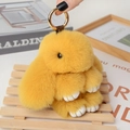 Yellow faux fur bunny plush keychain with golden metal ring and white leather paws - Large / Turmeric