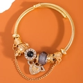 Golden woven bracelet with heart charm engraved Enjoy your life and black gemstone - Gray