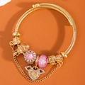 Golden beaded charm bracelet with pink crystals and a sparkling angel heart pendant - Pink