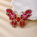Spilla vintage a farfalla dorata con strass colorati e intarsi in cristallo lucido - Farfalla Rosso Porpora
