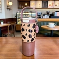 Insulated leopard print coffee tumbler in brown with a pink flower charm and handle - Coffee Leopard