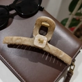 Matte beige marble claw clip with golden dog detail on a leather background - Khaki Pearl Gold Dog Hair Claw